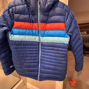 Cotopaxi Woman’s Puffer Jacket in Blue with Orange and Light Blue Accents